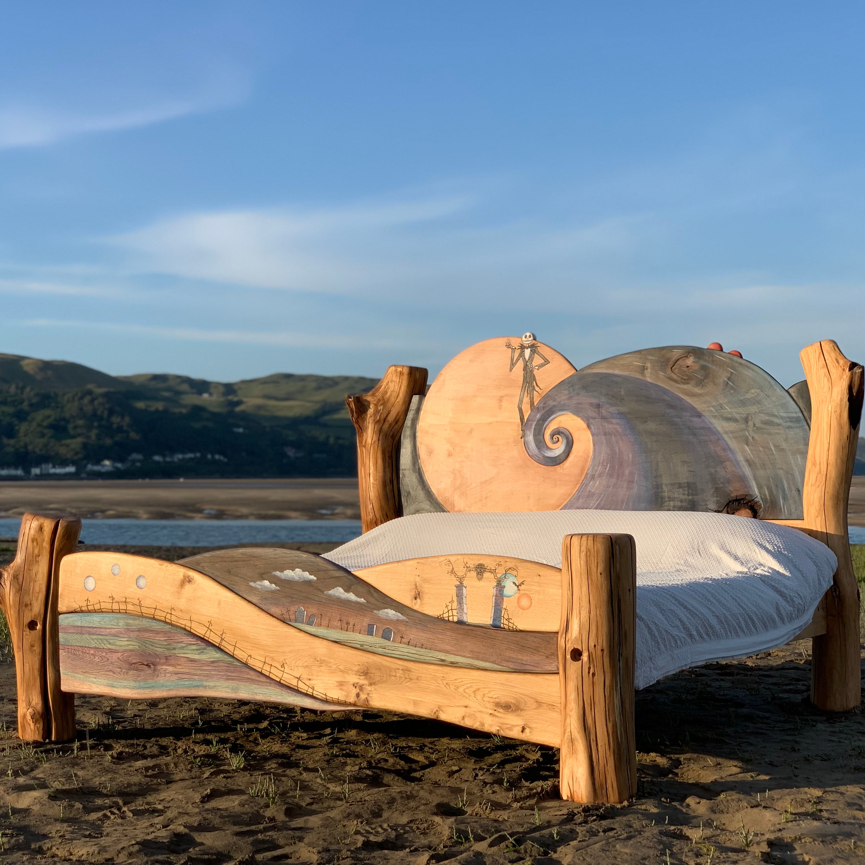 Custom-made bed frame adorned with Nightmare Before Christmas artwork, blending natural wood and fantasy elements.