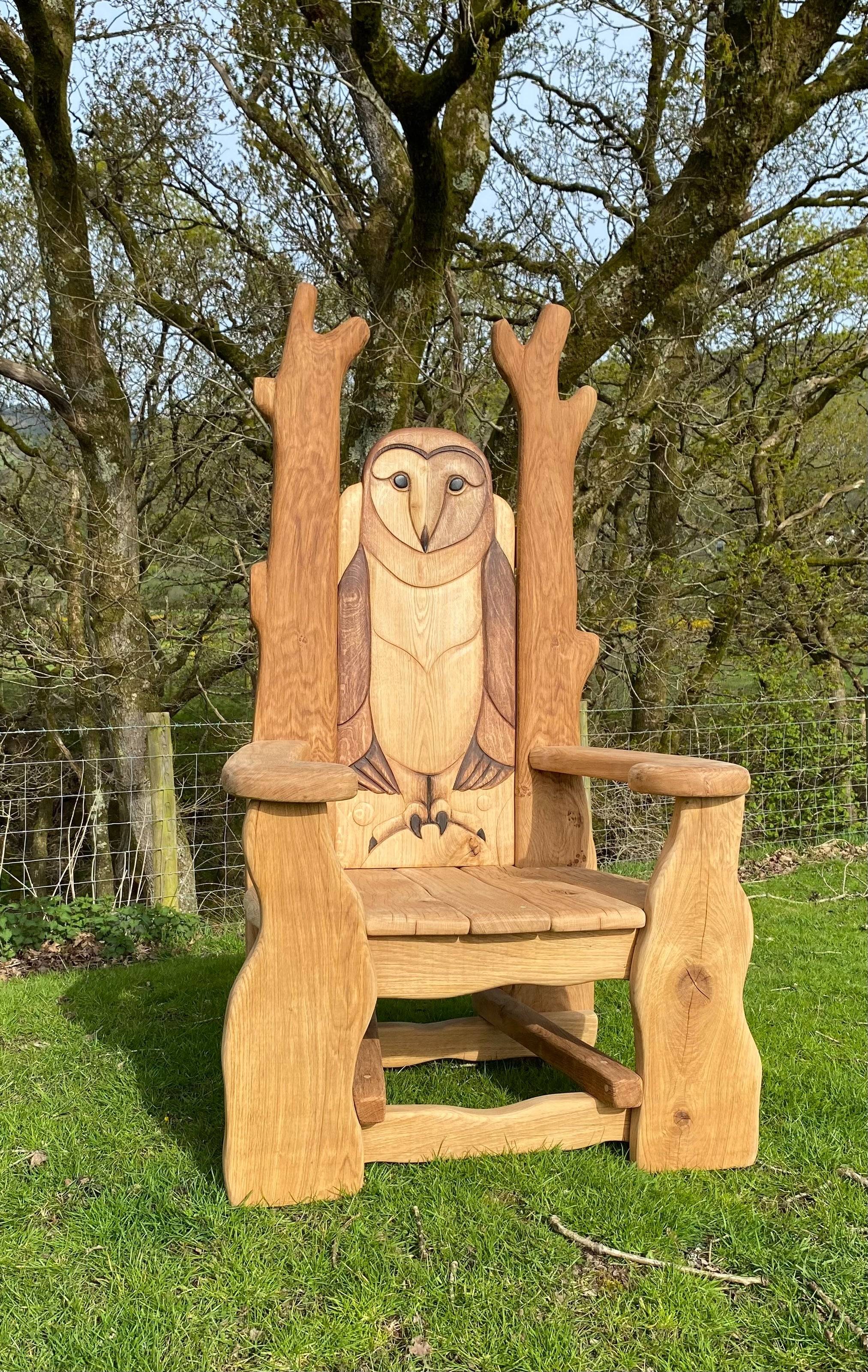 Outdoor carved owl reading chair in nature