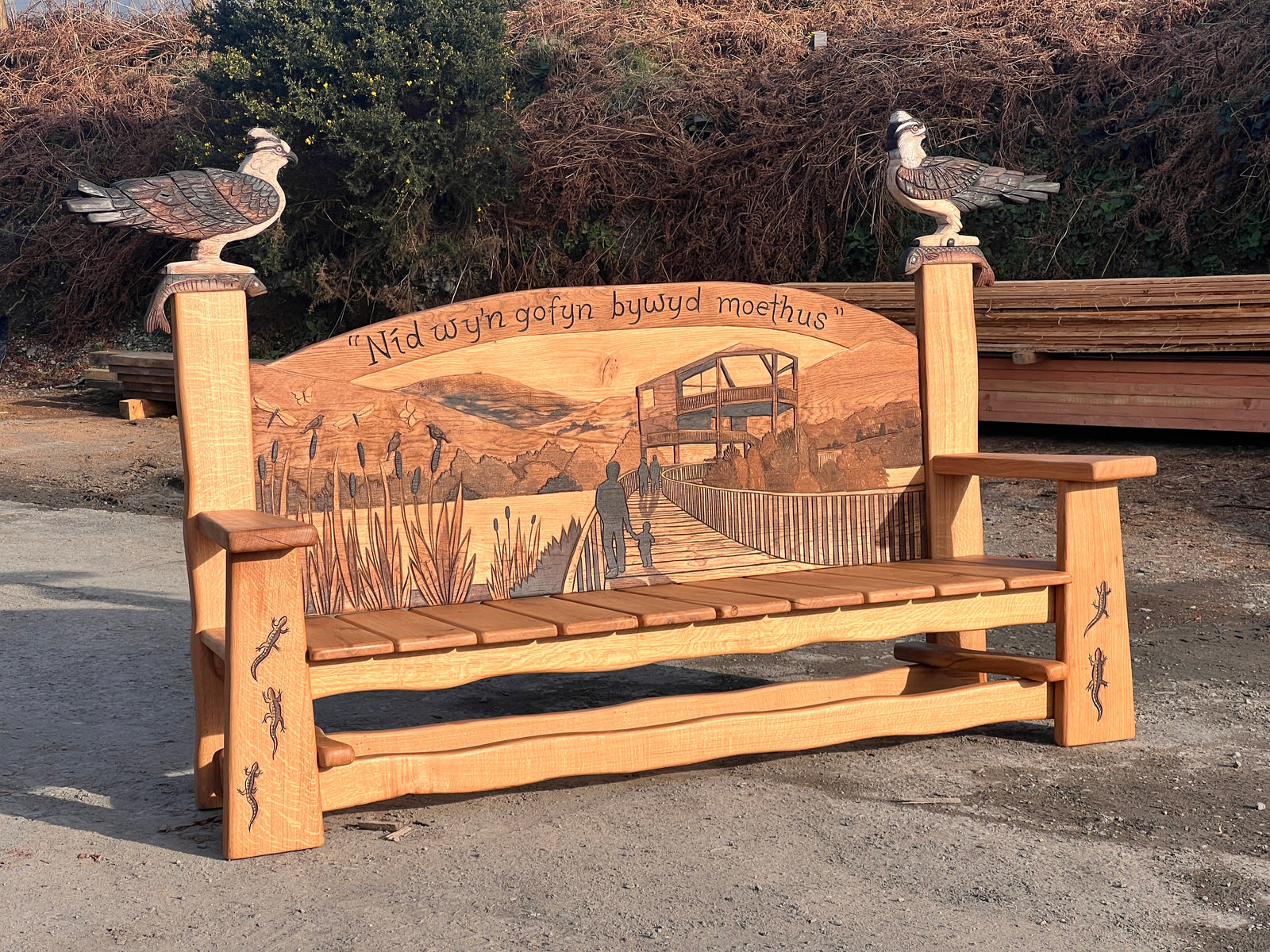 Carved family scene on the boardwalk depicted in the bench back panel relief