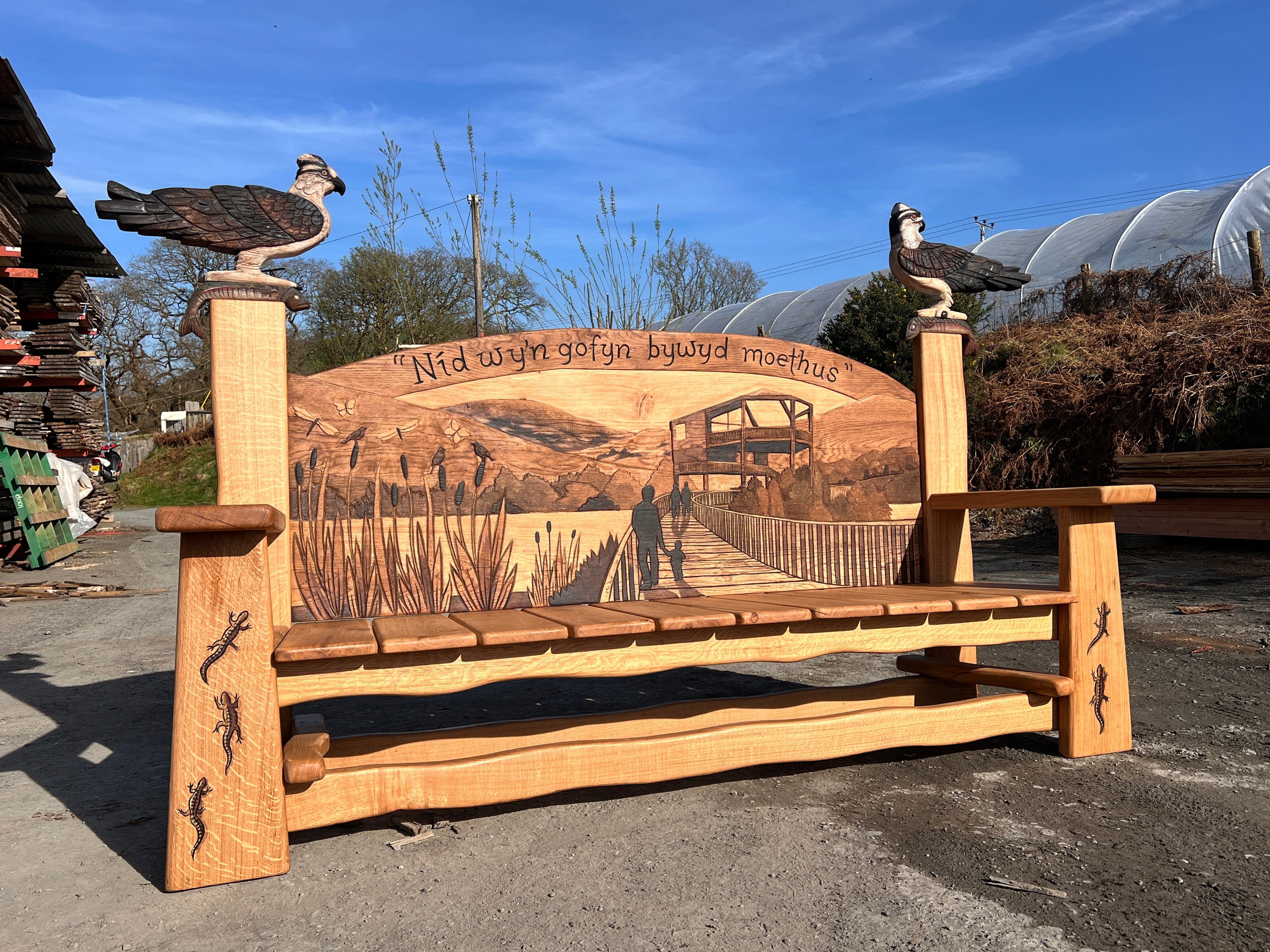 Close-up of carved osprey pillar with wings spread on the Ospreys Bench