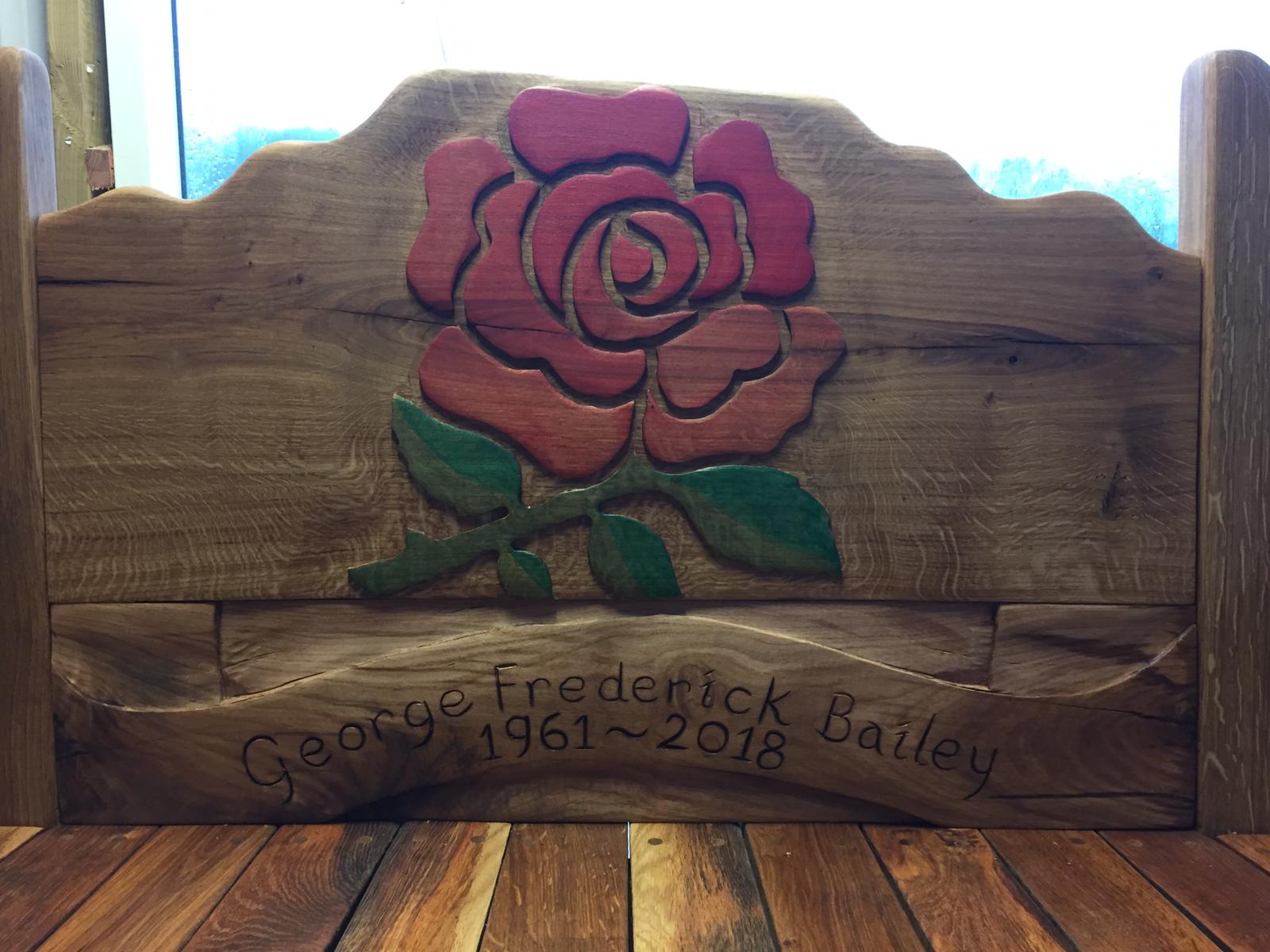 Close-up of rose engraving on wooden bench