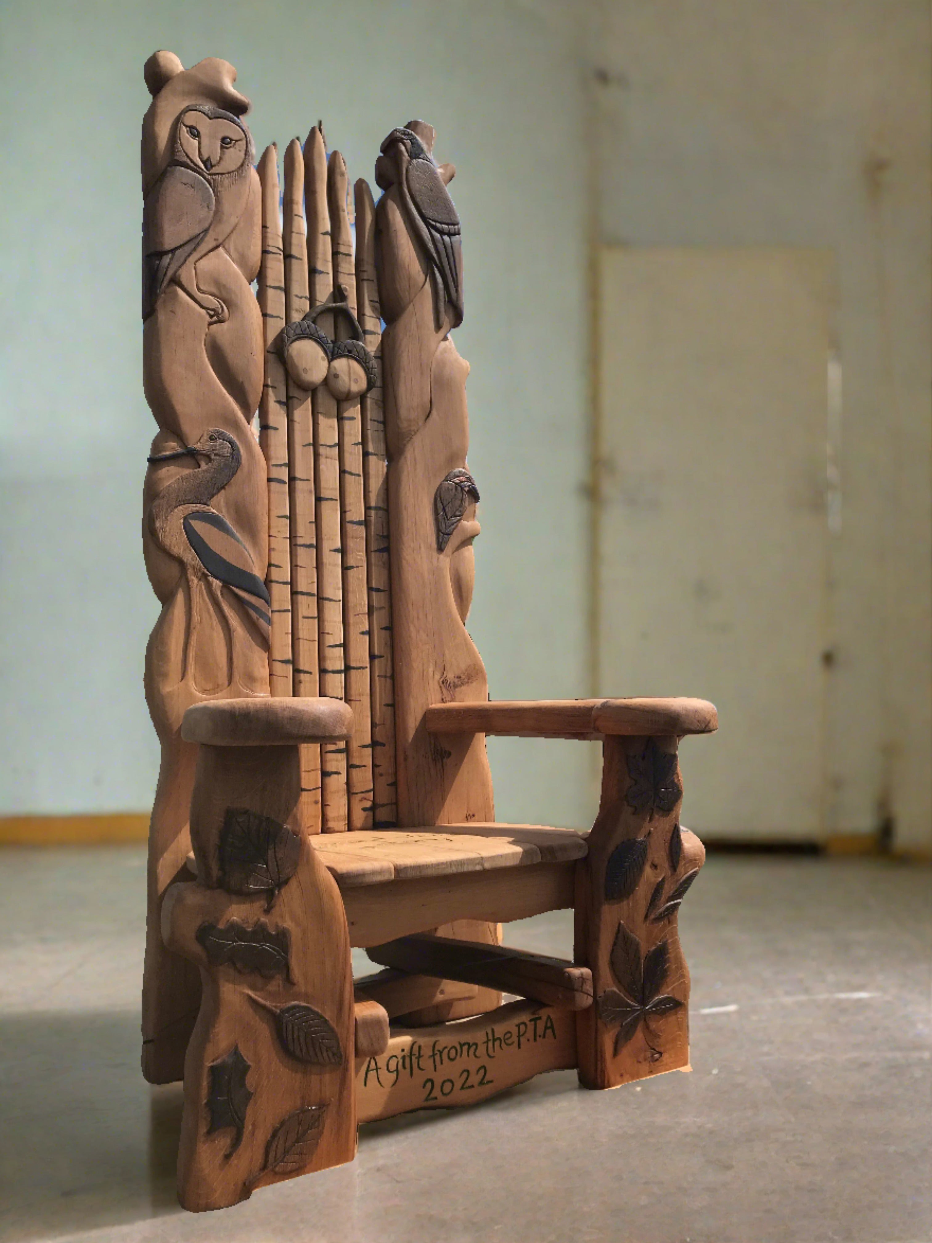 Wooden chair with bird carvings in school