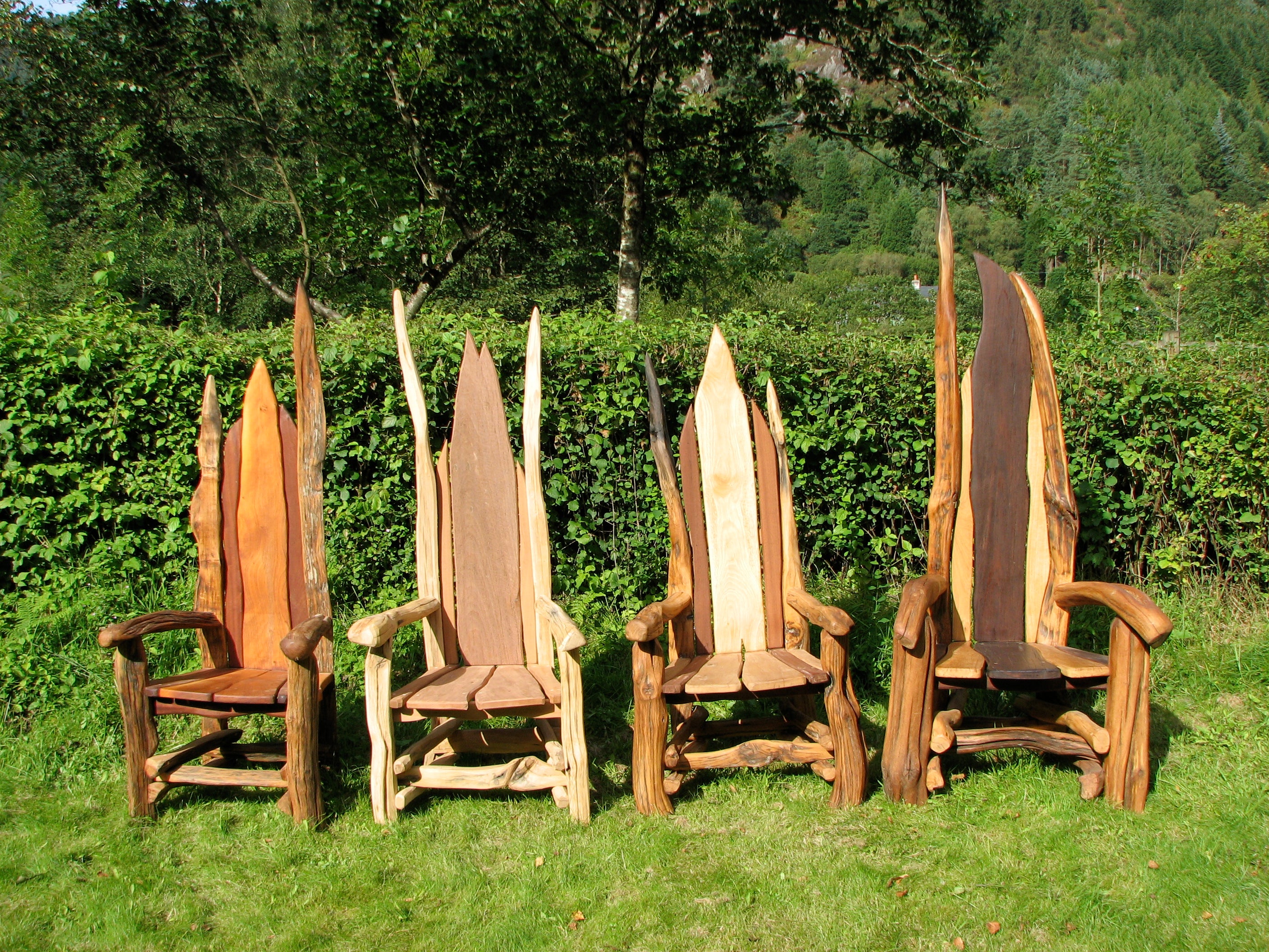 Two wooden chairs with branch designs