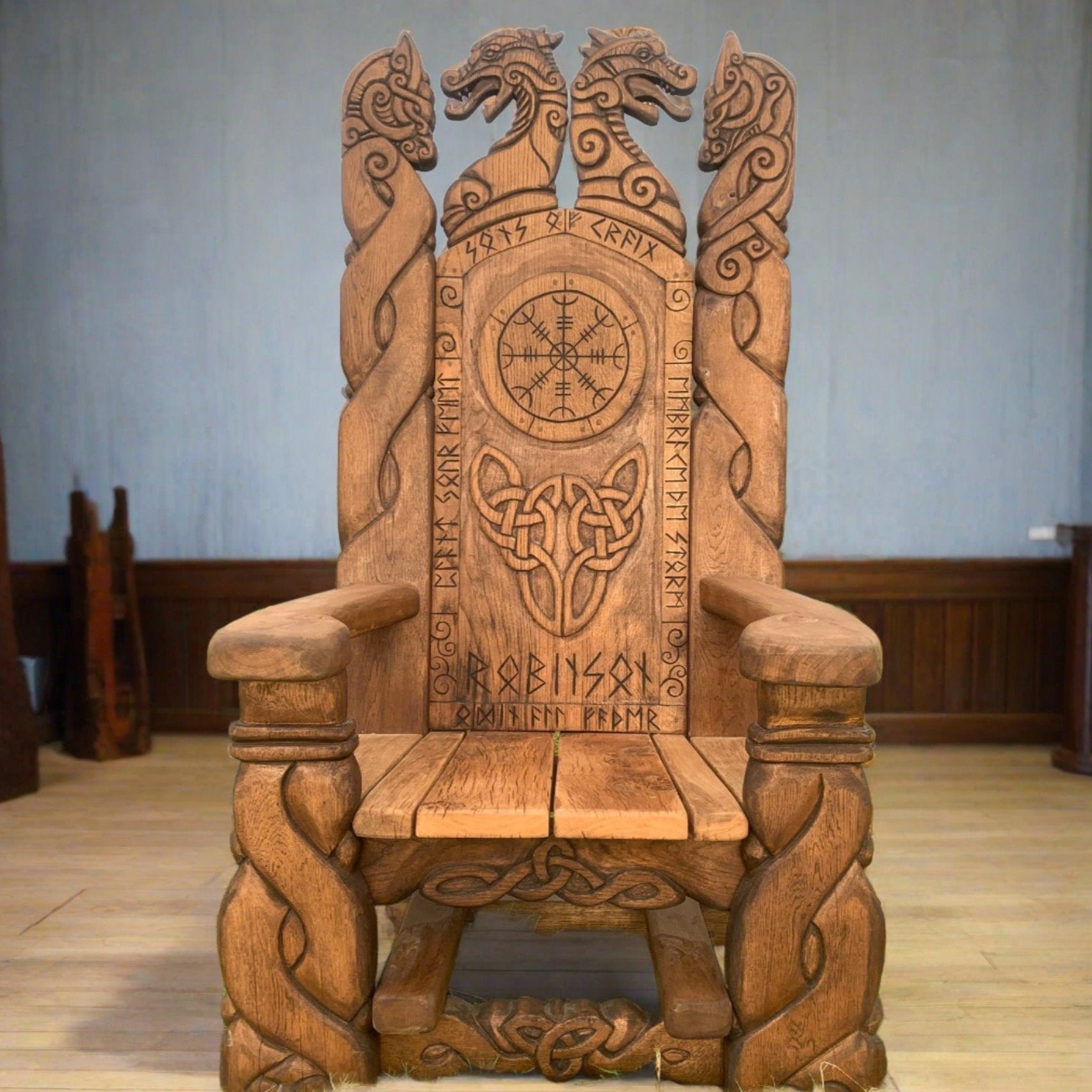 Handcrafted Viking chair with intricate carvings indoors