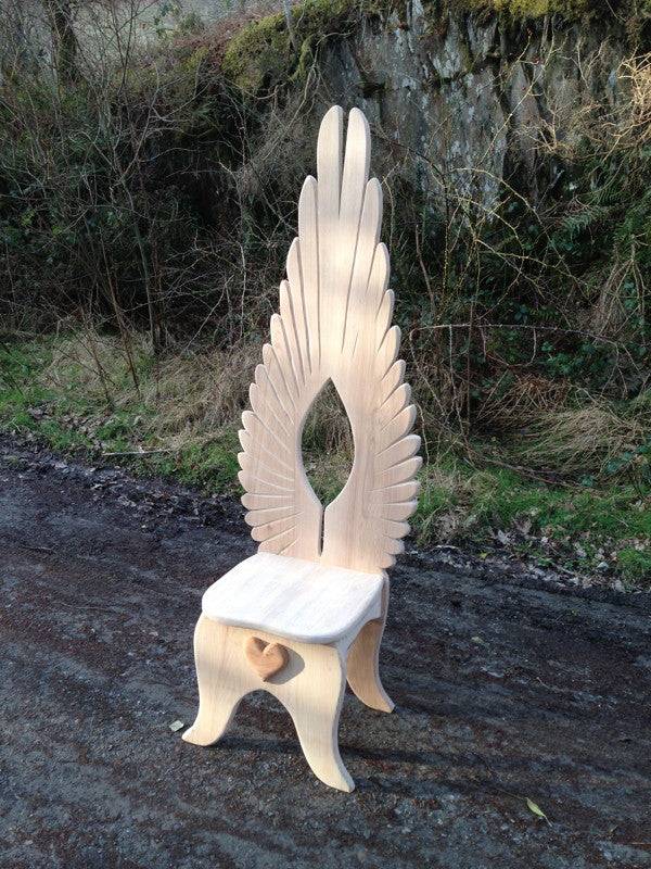 Hand-carved angel chair at dining table — bespoke oak furniture, Mid Wales
