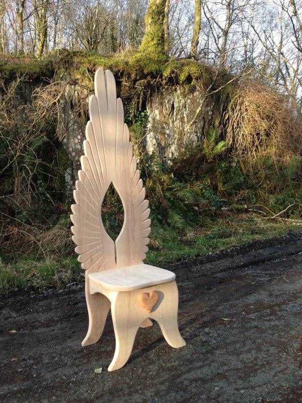 Side angle of carved oak angel dining chair — handmade fantasy furniture, Wales