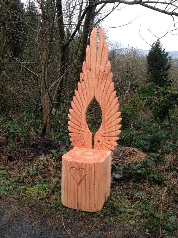 Side view of handcrafted oak angel storytelling chair — carved wing backrest, Wales