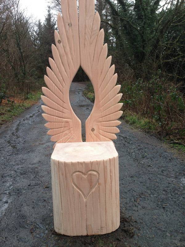 Angel wings carved into oak story chair backrest — handmade reading throne, Wales