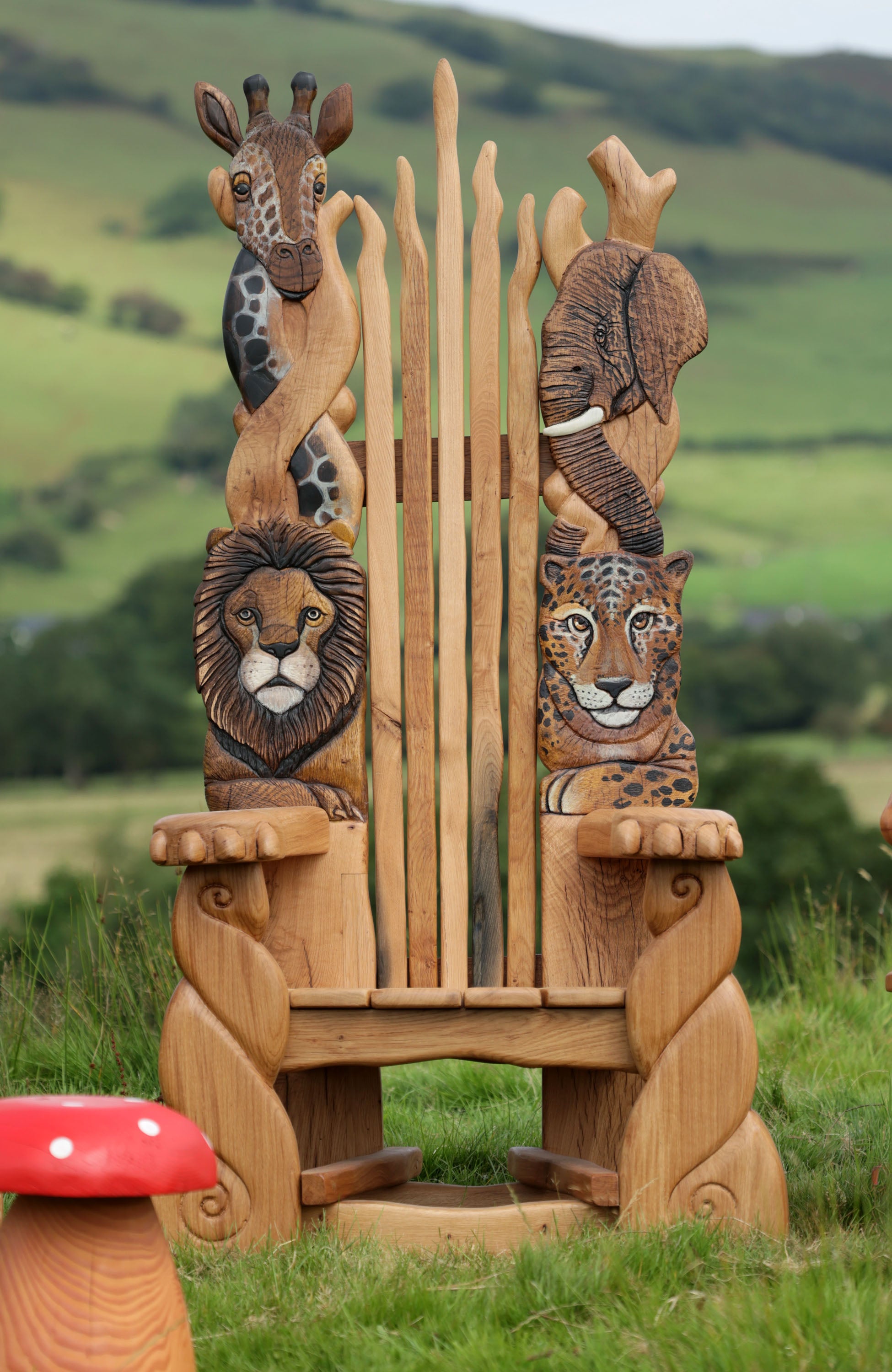 Wooden chair with animal head carvings in a natural setting