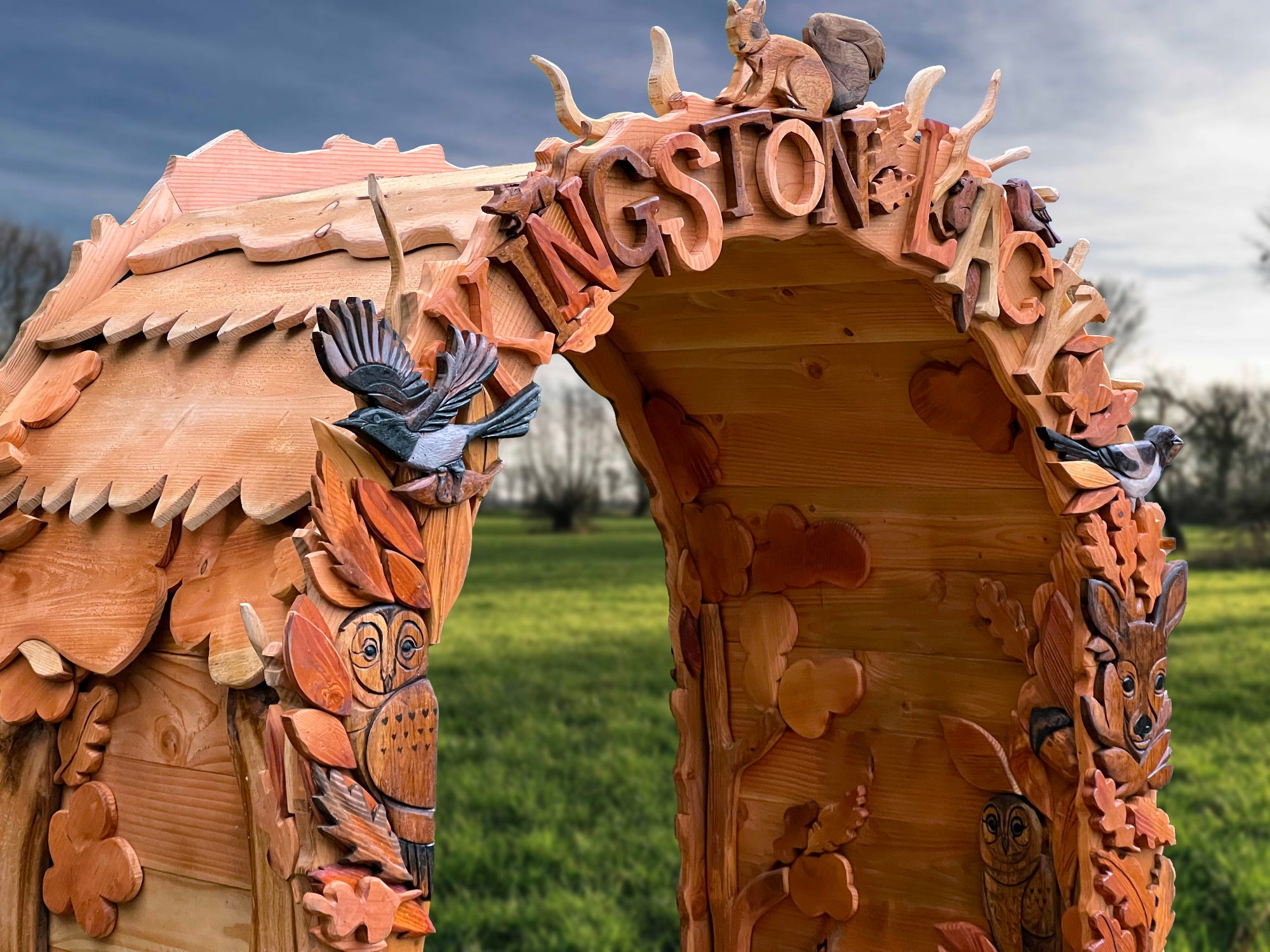 Wooden arch sculpture with intricate carvings and 'Kingston Lacy" heading