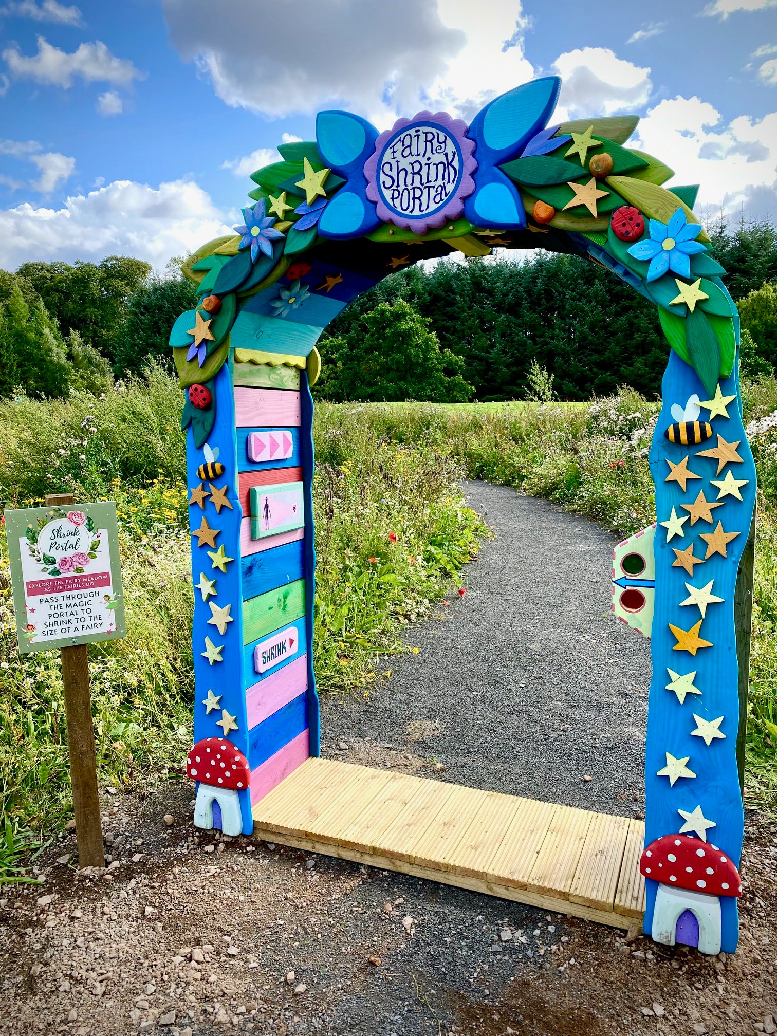 Colorful archway on a path surrounded by greenery