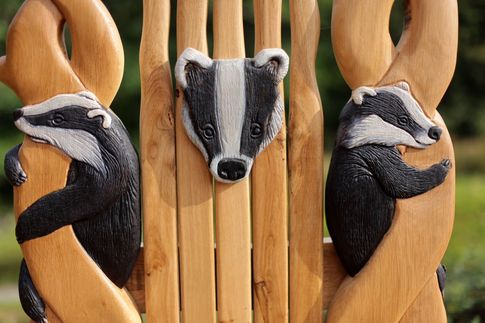 Carved badger backrest on handmade oak storytelling chair — bespoke wildlife furniture, Wales