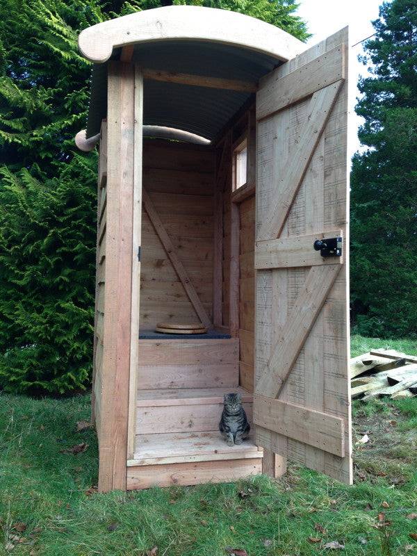 Doorway of basic handmade wooden bucket bog composting toilet — eco outdoor facility, Wales