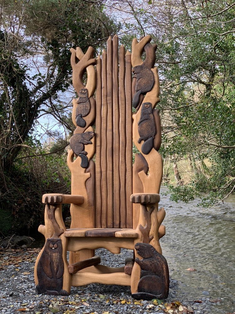 Close-up of carved beaver on handmade oak storytelling chair — bespoke wildlife furniture, Wales