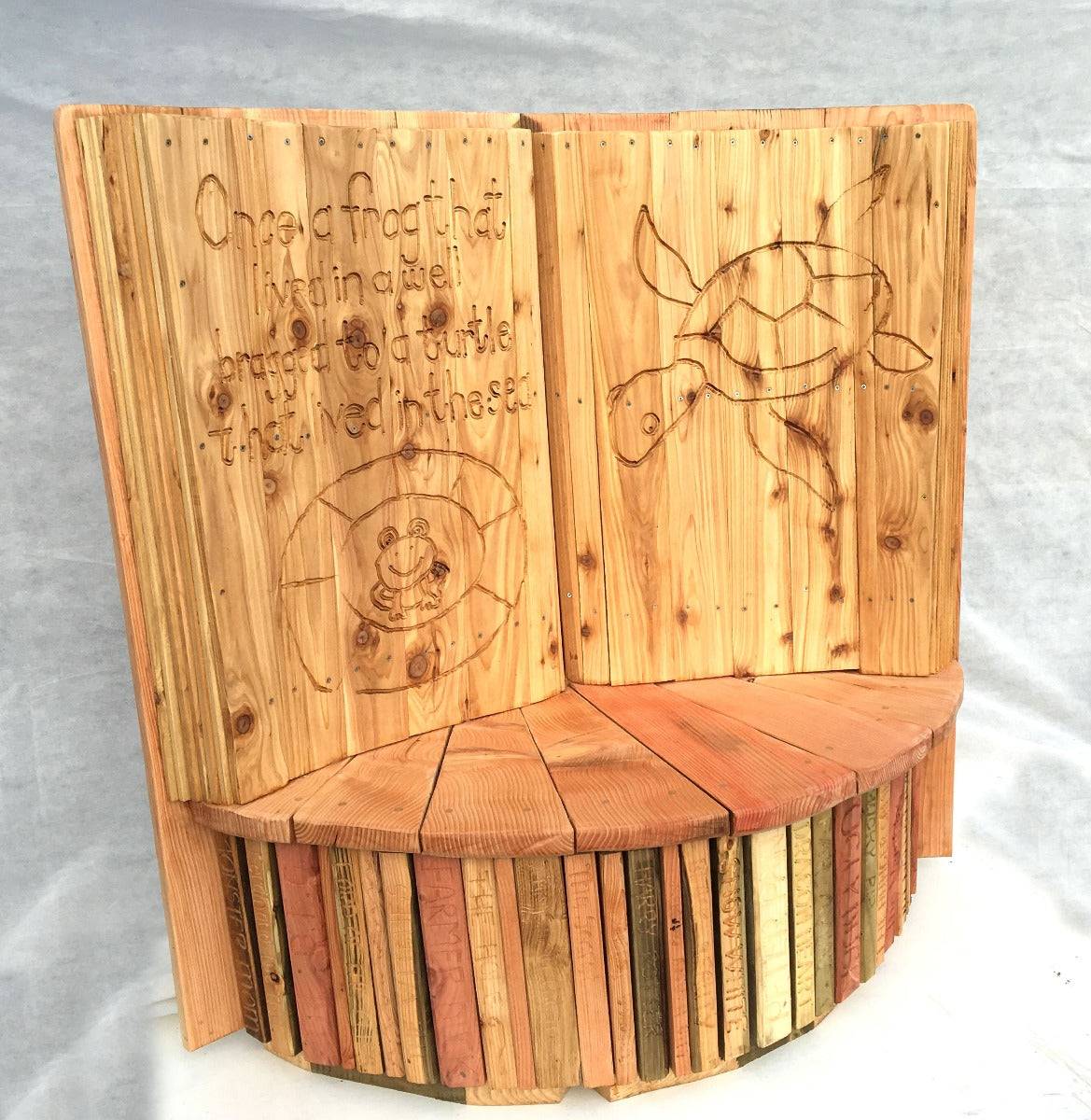Story time carved oak book chair in playground — handmade school furniture, Wales