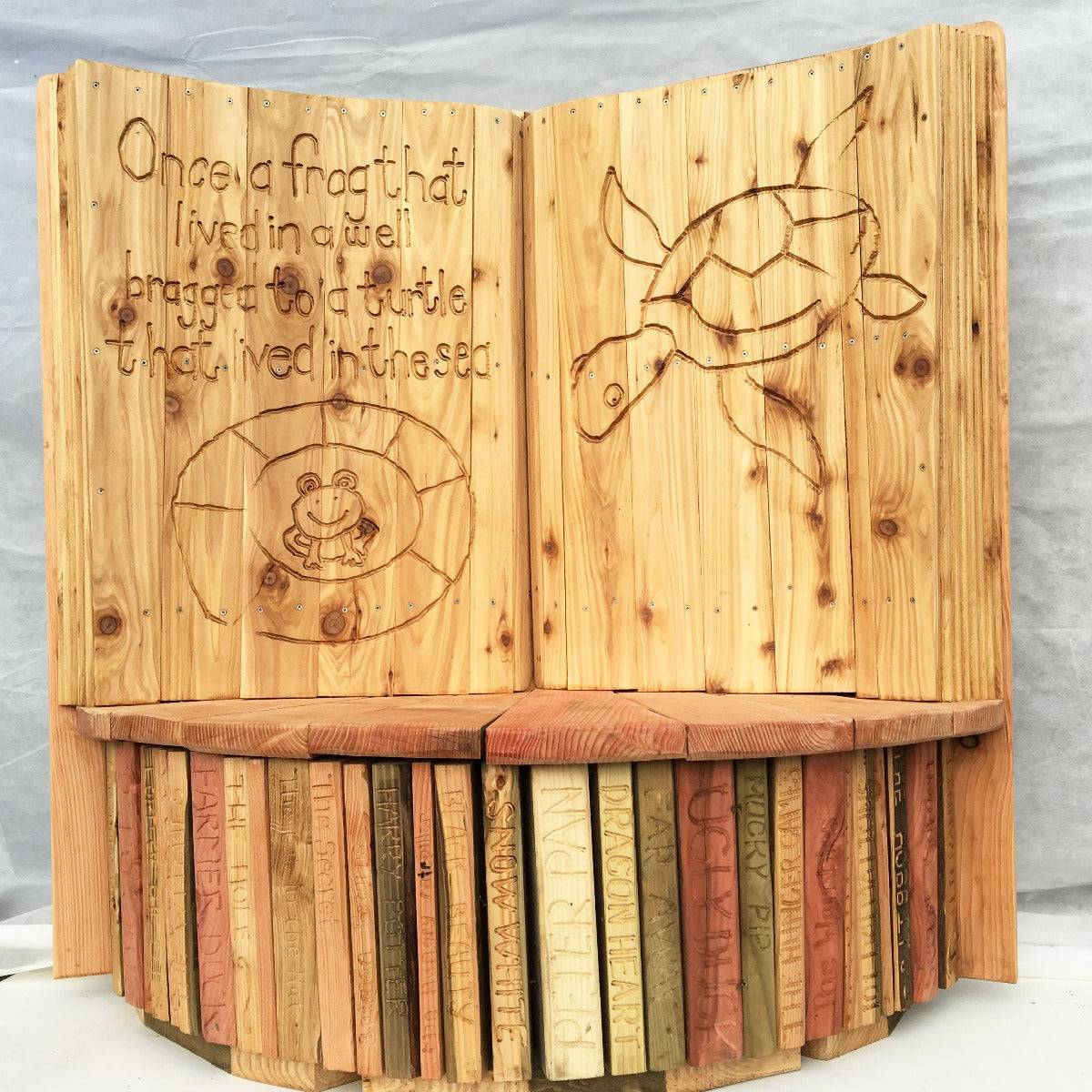 Giant carved oak book chair for school playground — handmade in Wales