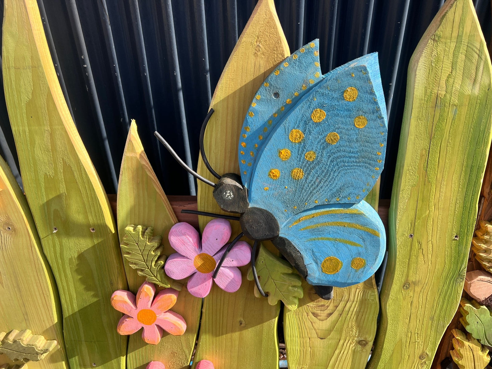Hand-carved leaf and insect detail on Bug Trail archway — bespoke, Wales
