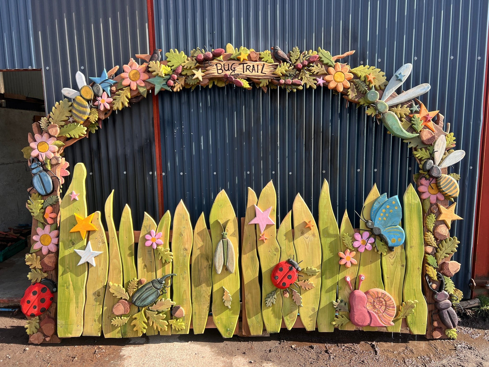 Hand-carved Bug Trail archway — bespoke nature trail entrance, Wales