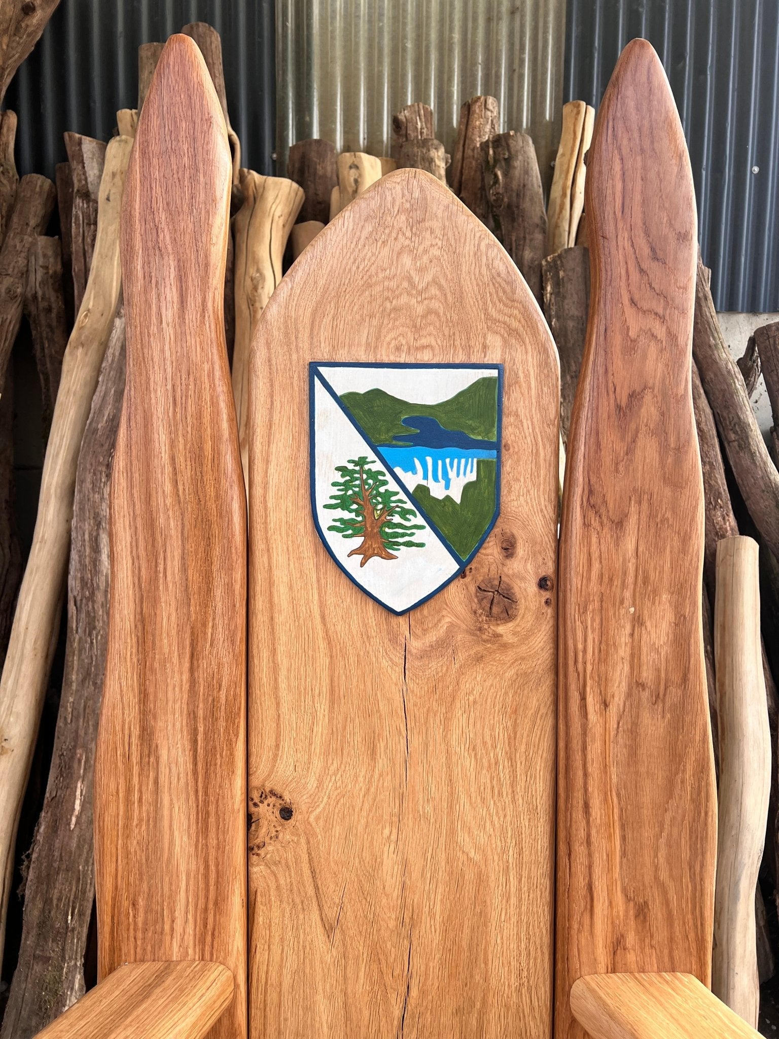 closeup of Logo Hand-Carved into Solid Wood Storytelling Chair Backrest