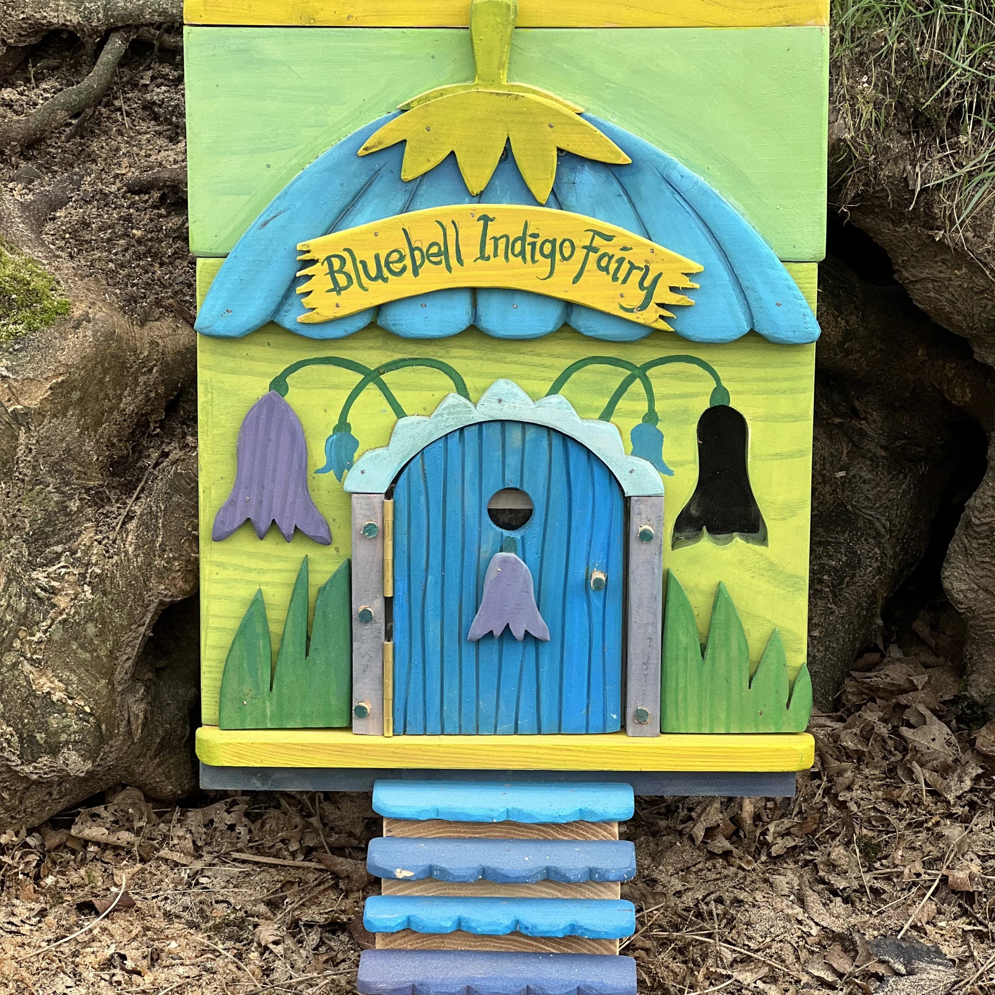 Handmade bluebell indigo fairy house with deep blue painted walls and wall-mounted fairy door design