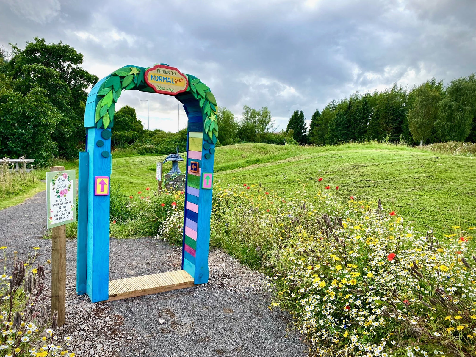 Handmade carved oak archway in colourful garden setting — bespoke, Wales