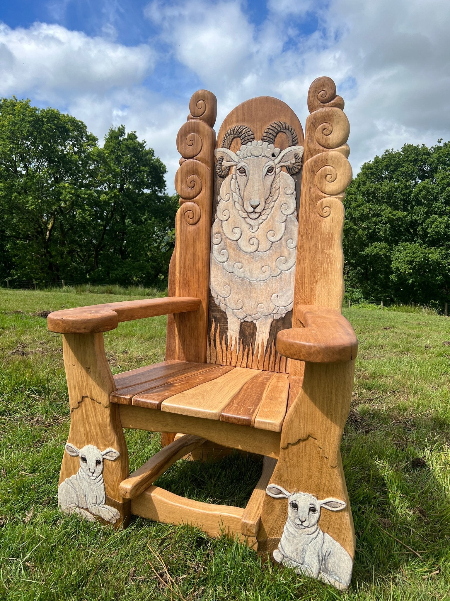 Front view of sheep storytelling chair in outdoor setting — handmade solid oak, Wales