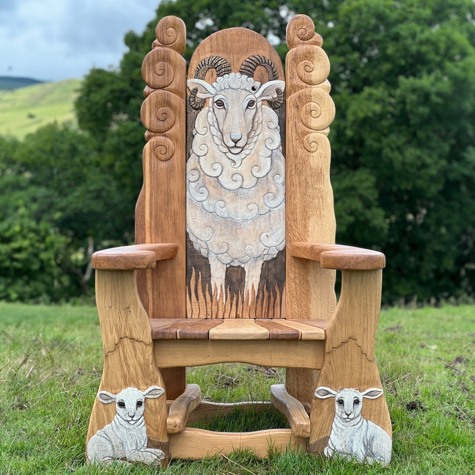 Hand-carved oak storytelling chair with sheep design — bespoke, handmade Wales