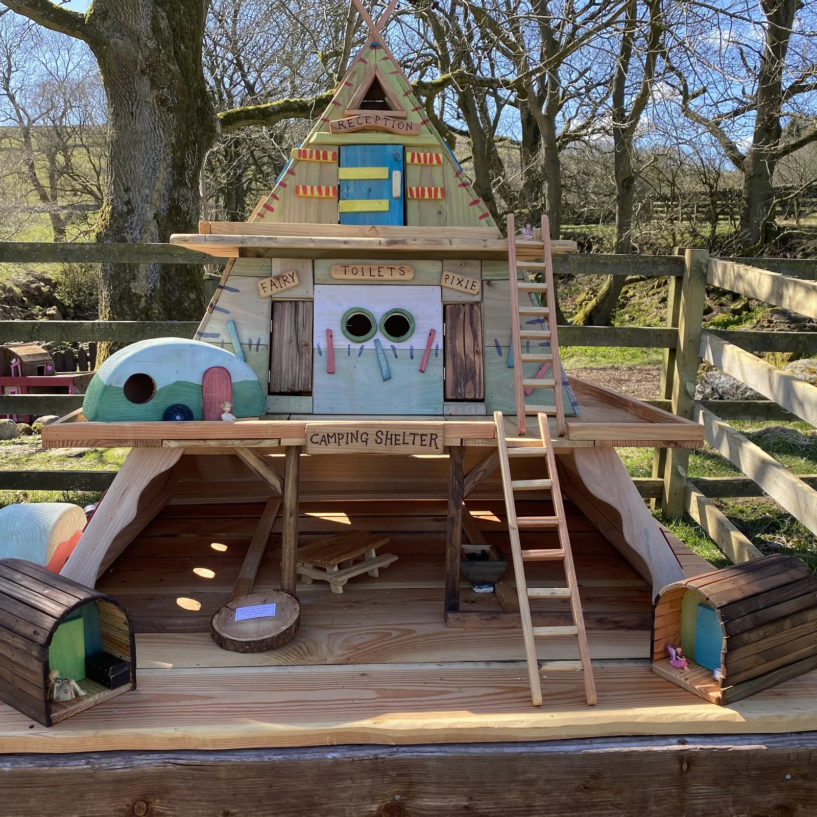 Handmade fairy camping village with A-frame reception building, fairy toilet block and dome camping shelters