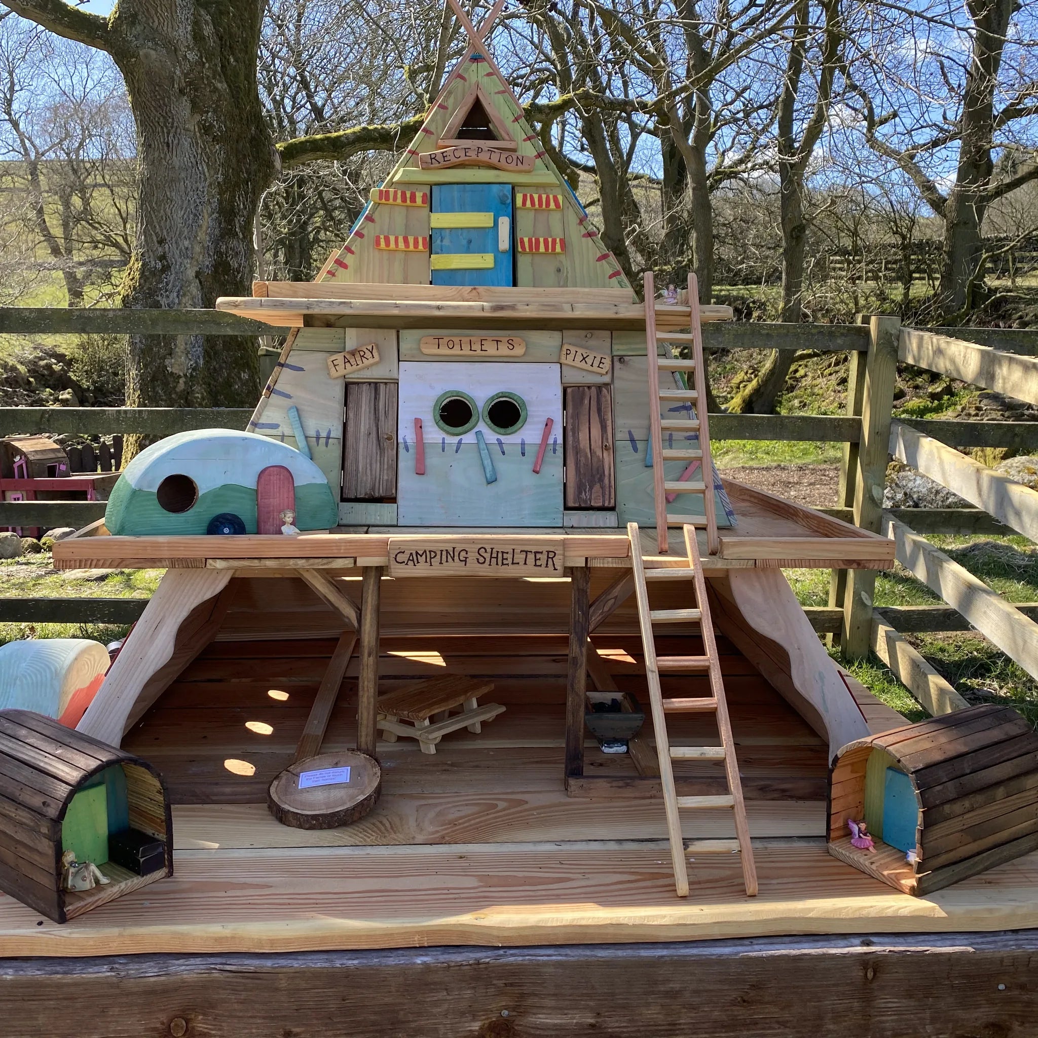 Handmade fairy camping village with A-frame reception building, fairy toilet block and dome camping shelters