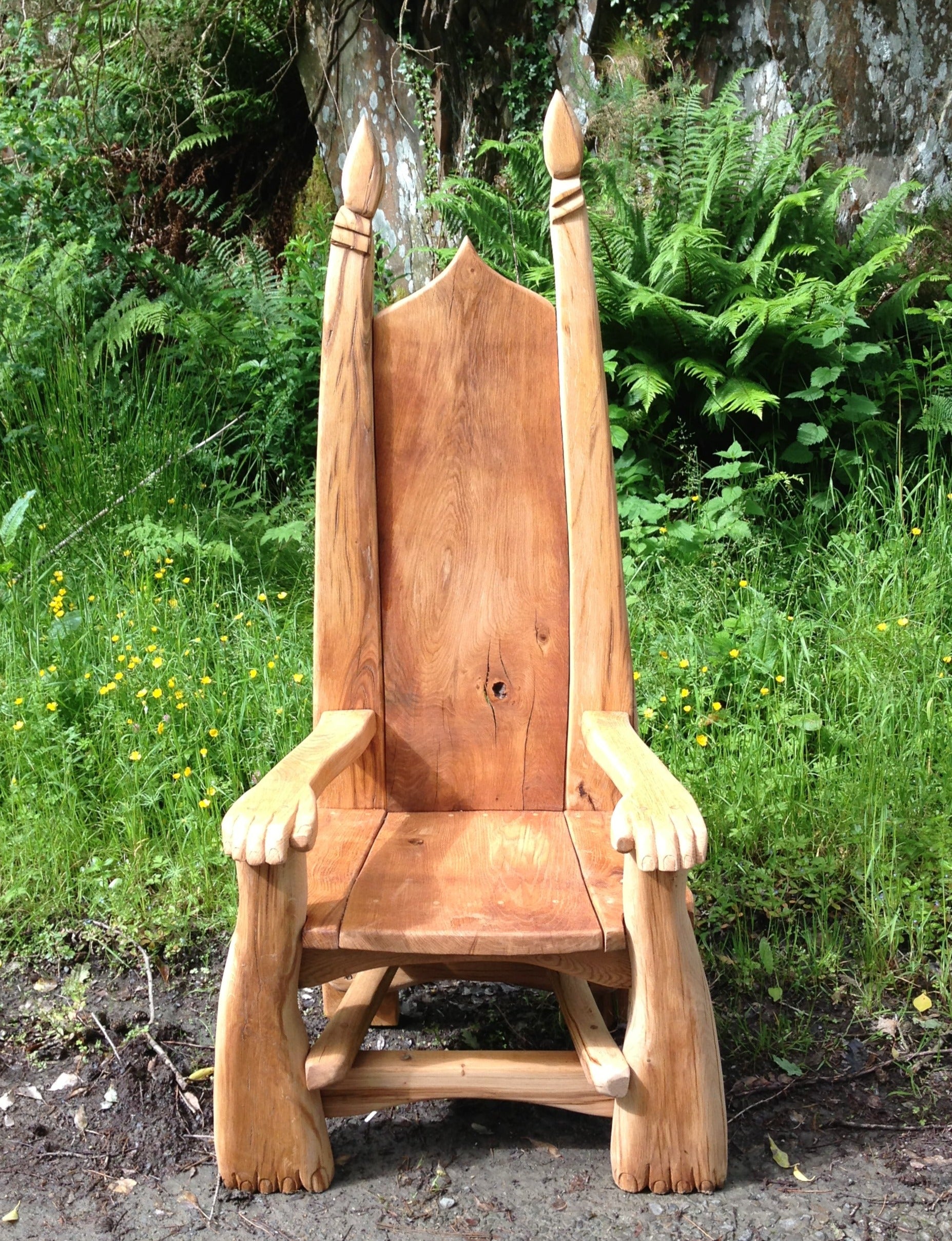 Wooden chair with paw armrests in garden