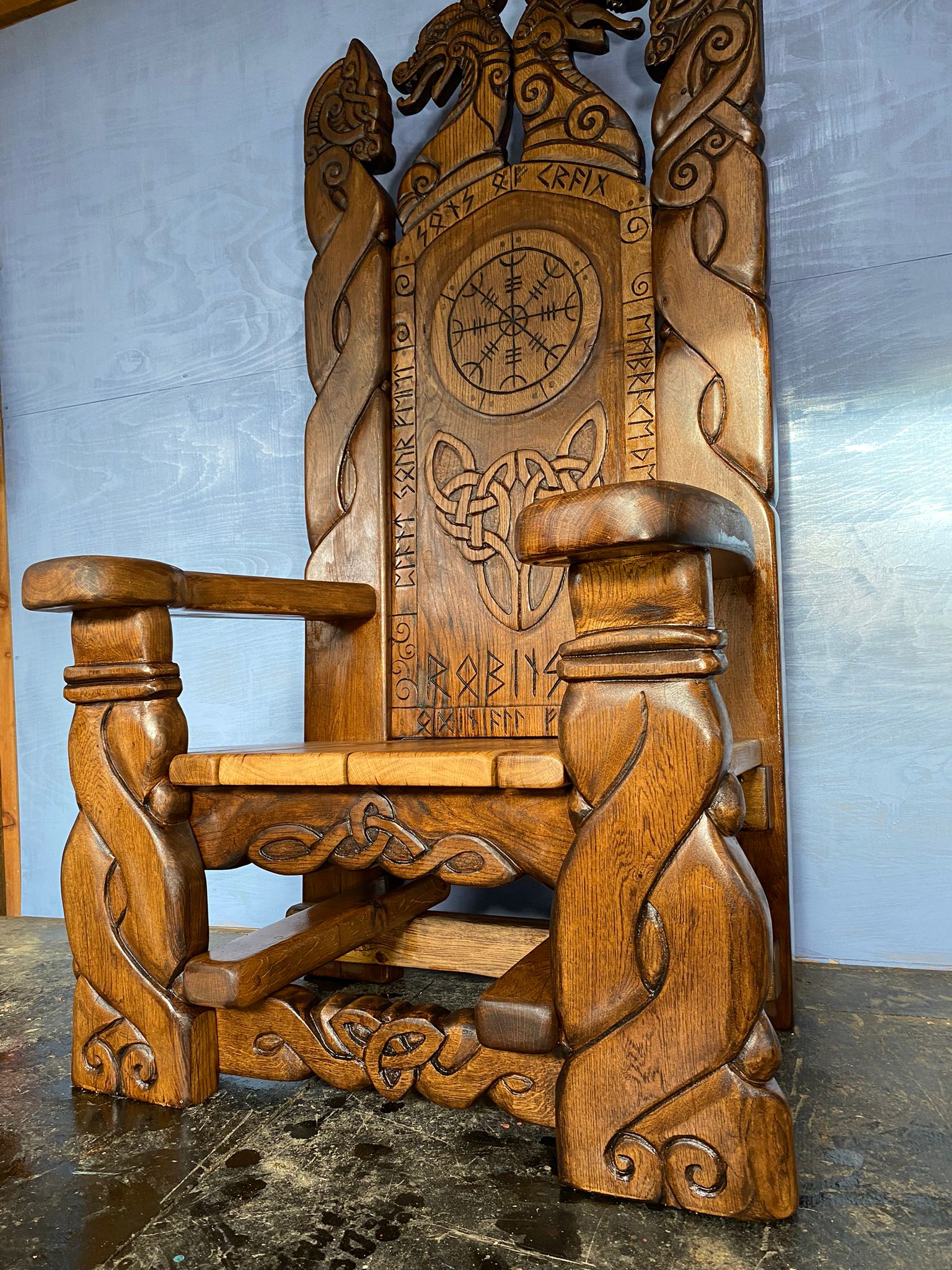 Side view of carved Welsh oak Celtic Viking throne — handmade bespoke furniture, Wales