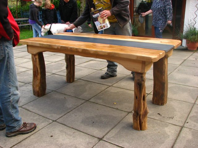 Chunky handmade solid oak patio table being oiled — bespoke, Wales