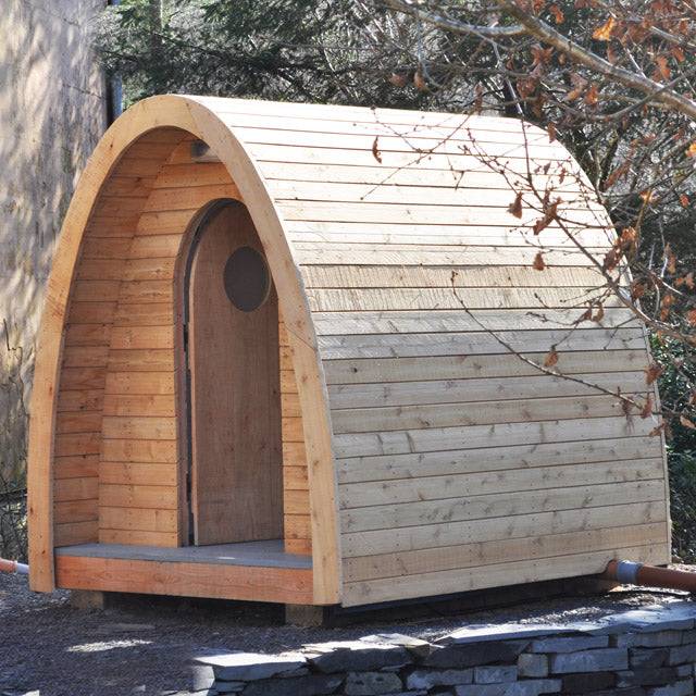 Timber Arc Composting Toilet with a unique half-ellipse design, crafted from sustainable wood, ideal for eco-friendly waste management in outdoor settings