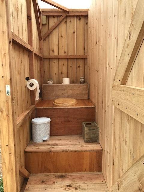 Close-up of Outdoor Shower and Composting Toilet Unit, featuring a clear roof for natural light and sustainable materials for glamping and campsites