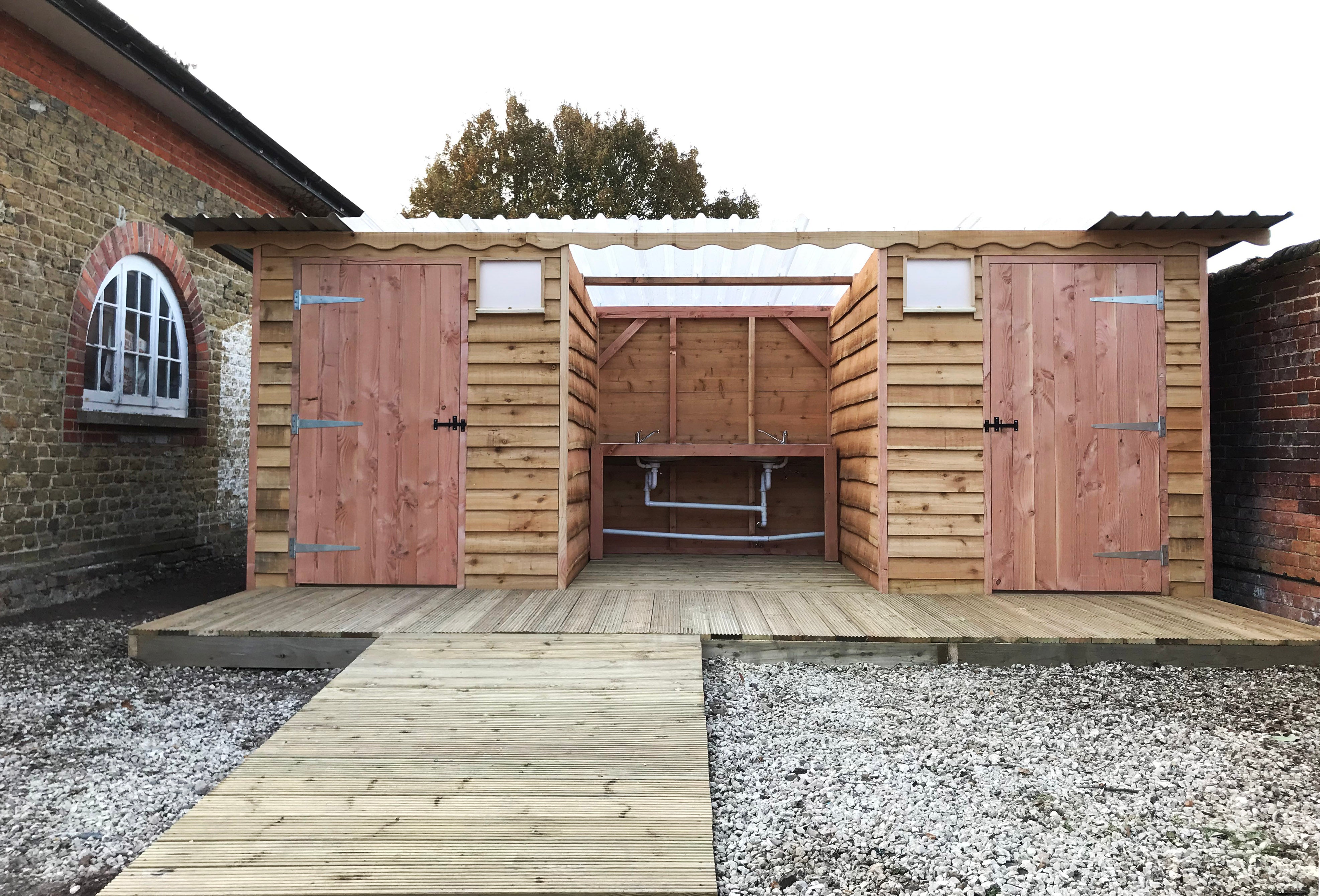 Disabled-access compost toilet with integrated washroom and wheelchair accessible ramp