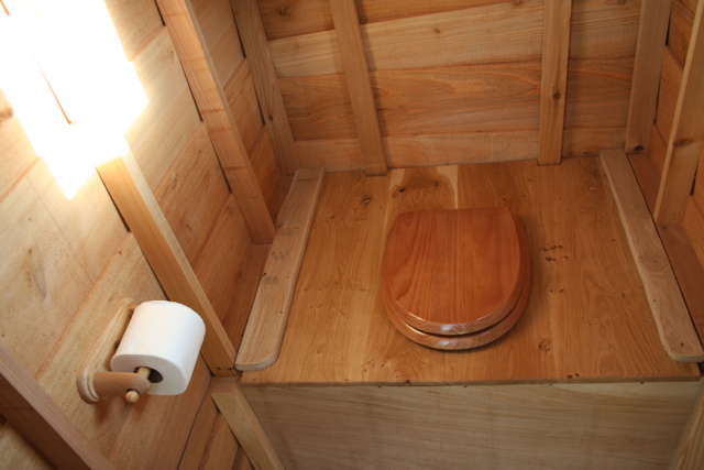 Interior view of wooden composting toilet with seat