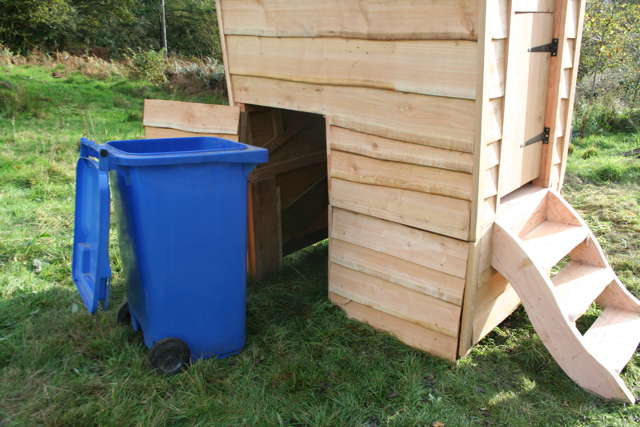 Compost toilet with blue wheelie bin