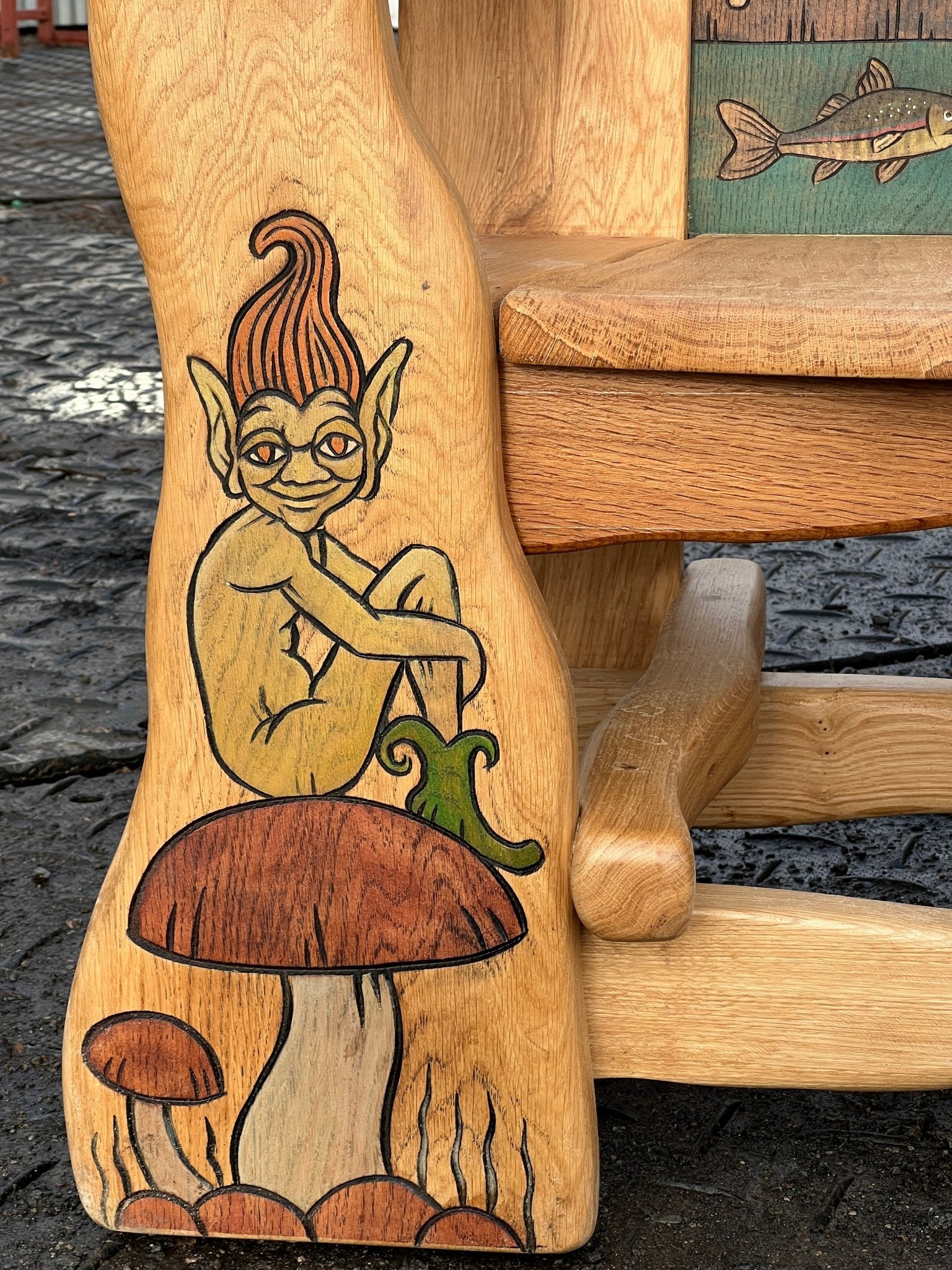 pixie carved on storytelling chair leg