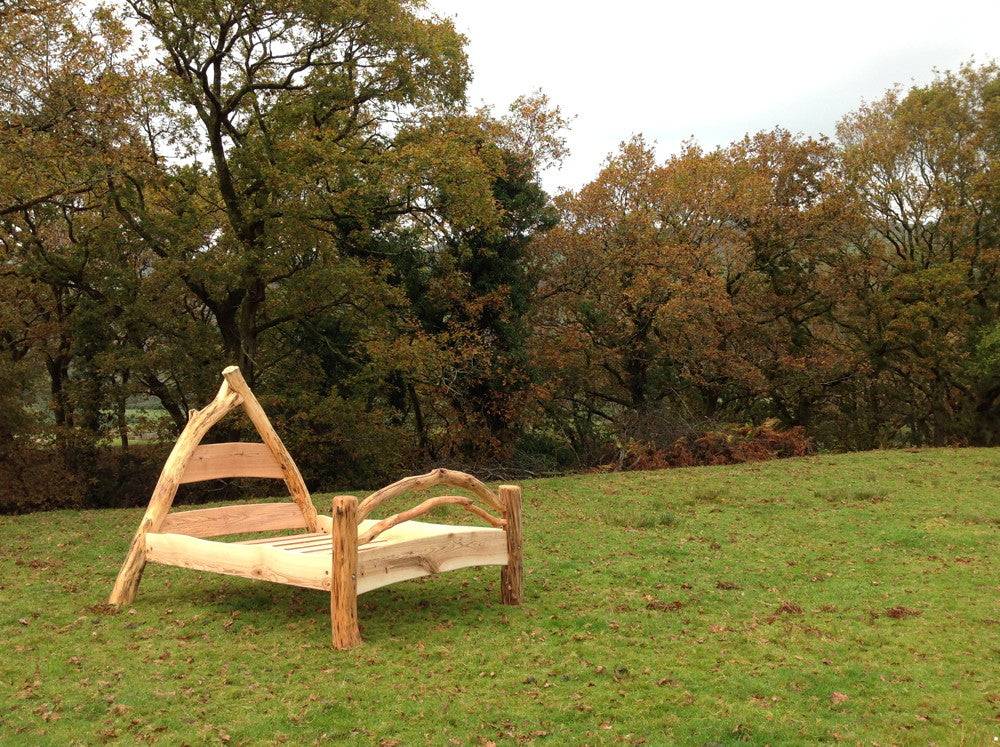 Mortice and tenon joints on handcrafted cruck frame bed — traditional oak joinery, Wales