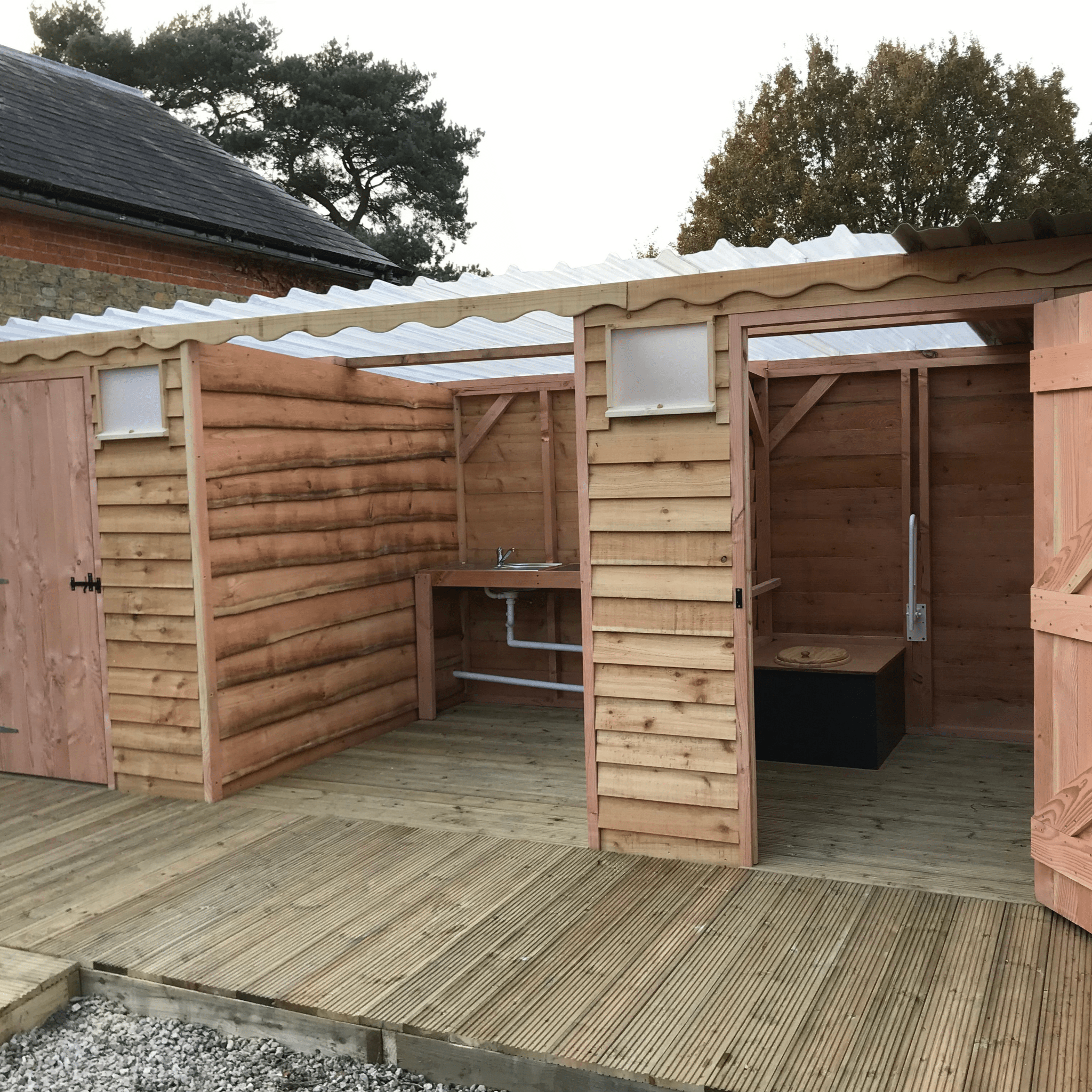 Wooden Disabled Access Compost Toilet Block with two wheelchair-accessible toilets and a central handwashing area, featuring a stylish design and eco-friendly construction