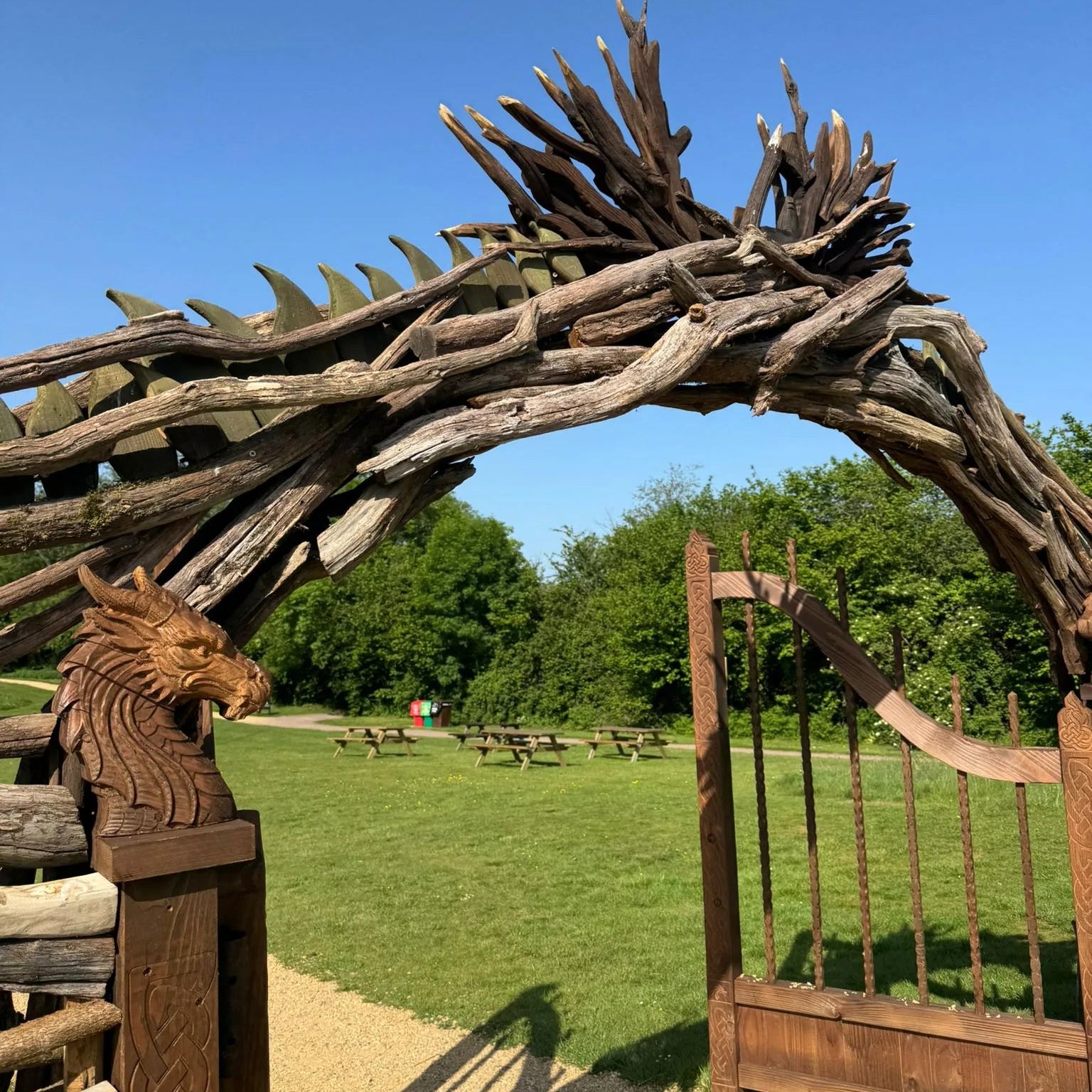 Craftsman installing dragon arch fin details on site using a nail gun working at height on the driftwood structure