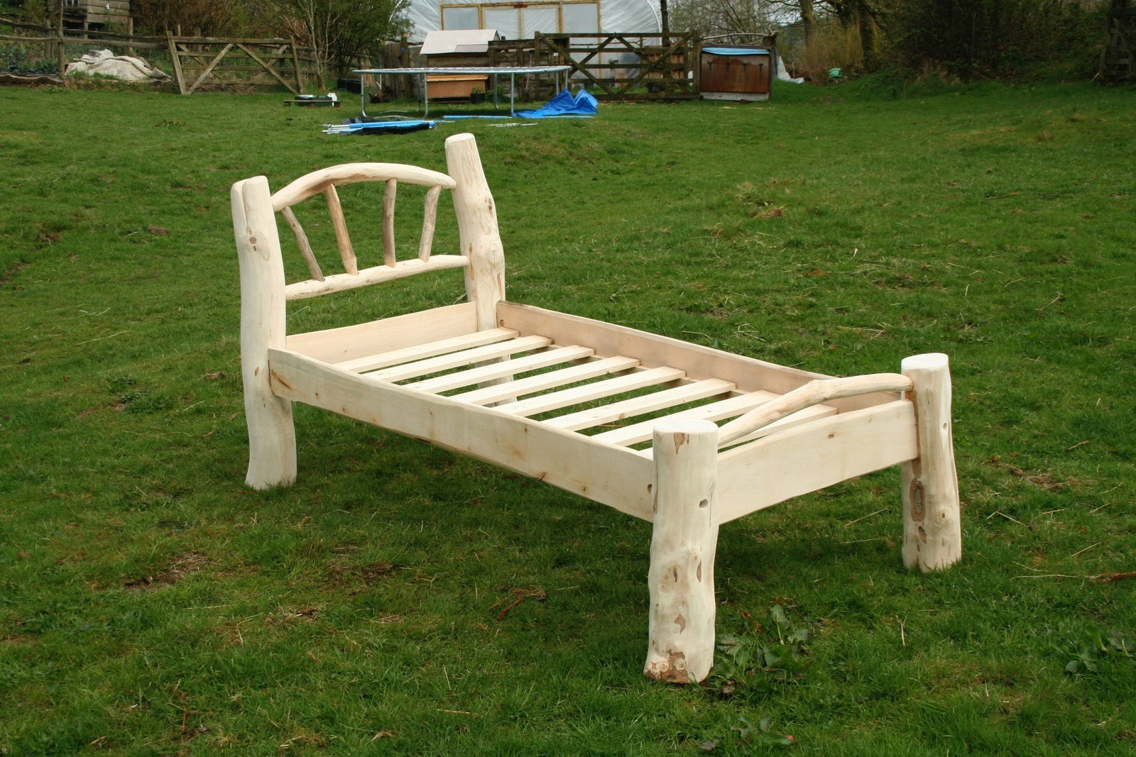 Rustic driftwood bed frame close-up — handmade natural coastal wood furniture, Wales