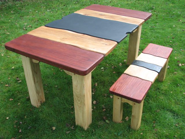 Handmade slate and Jarrah table with bench in garden — bespoke, Wales