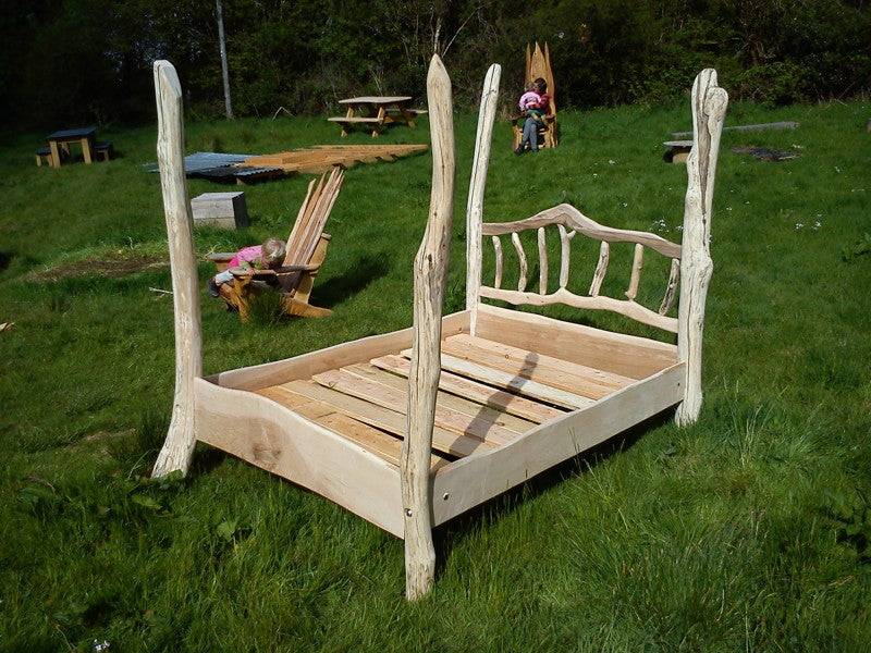 Driftwood four poster bed frame outdoors — handcrafted natural wood furniture, Wales