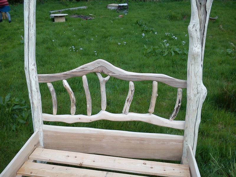 Spalted driftwood headboard on handmade four poster bed — natural wood furniture, Wales
