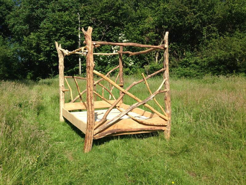 Handcrafted solid oak four poster tree driftwood bed — bespoke natural wood bedroom furniture, Wales