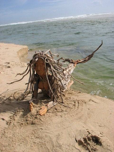 Driftwood mermaid wall sculpture in situ — natural art handmade in Wales