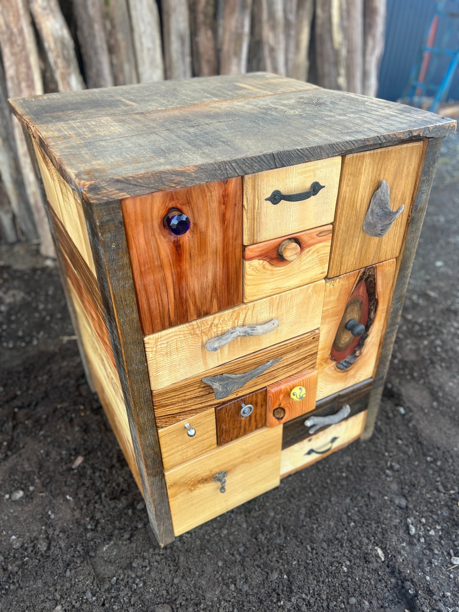 Front view of handmade patchwork chest of drawers made from driftwood and mixed hardwoods — bespoke, Wales