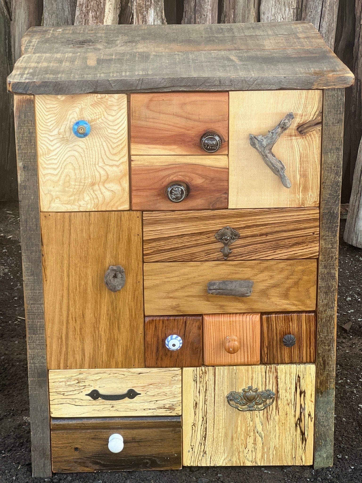 Close-up of quirky drawer knobs and natural textures on handcrafted patchwork wooden furniture