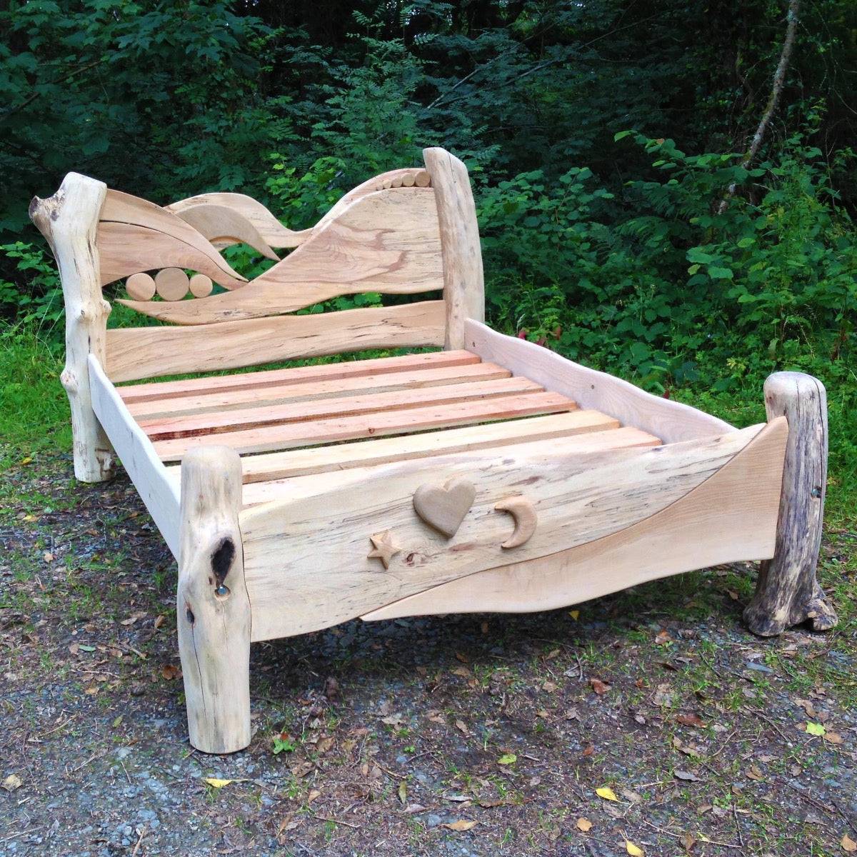 Driftwood wave bed with spalted beech headboard in outdoor setting — fantasy oak bed, Wales
